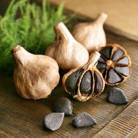 Healthy black garlic plants growing in a vegetable garden
