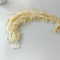 Preserved ivory amaranthus used to decorate a wedding arch and event backdrop.