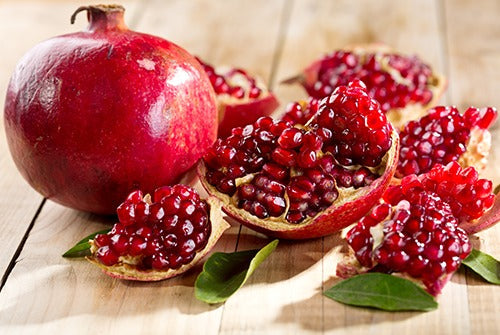 Pomegranate tree with bright red flowers